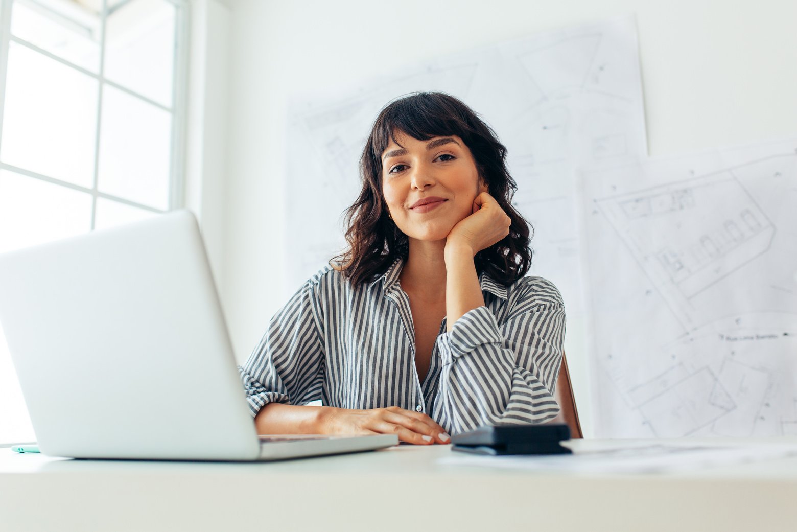 Woman architect sitting at office desk